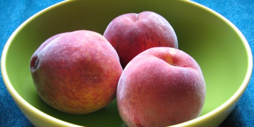 Bowl of peaches in cloud lighting